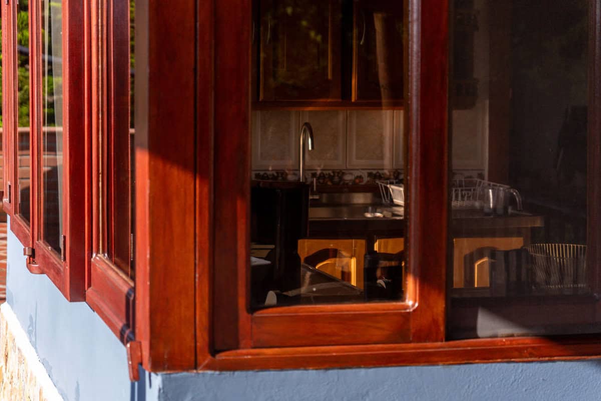 Warm wooden window frame at CMS Finca Conejo Blanco, showcasing rustic charm and natural materials.