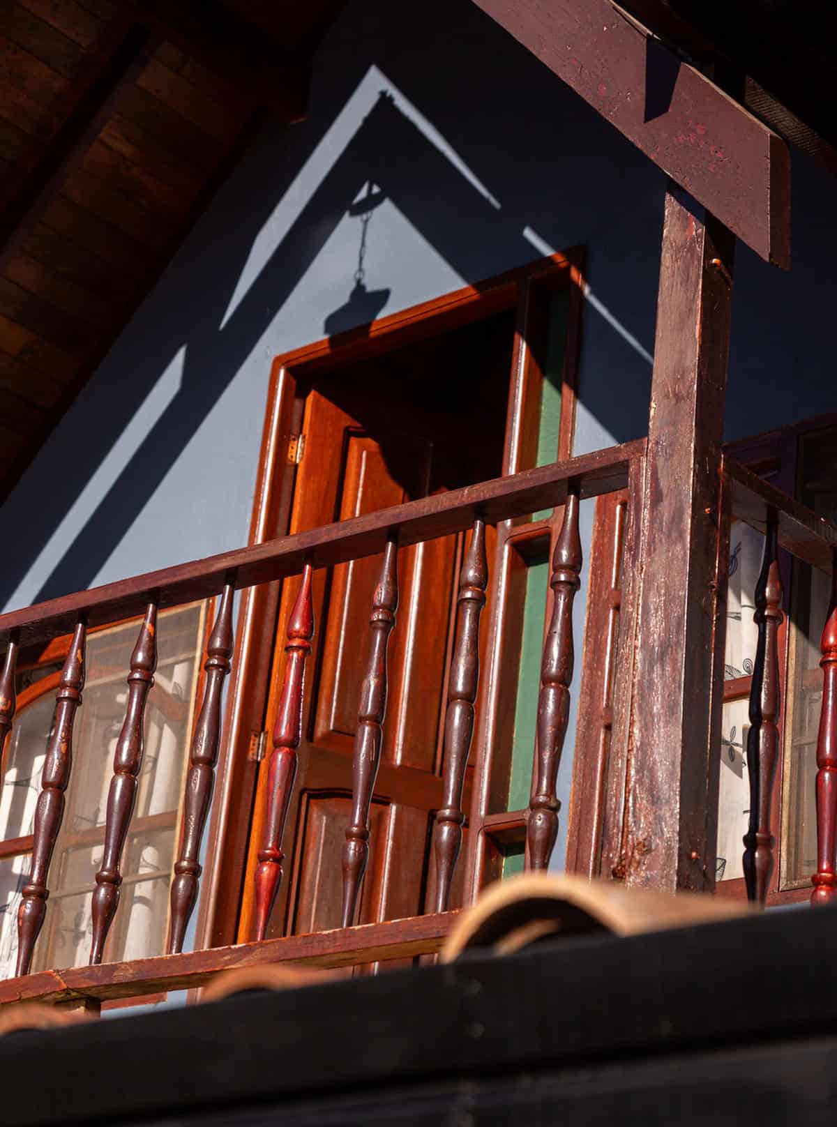 Rustic wooden balcony at CMS Finca Conejo Blanco, showcasing traditional craftsmanship.