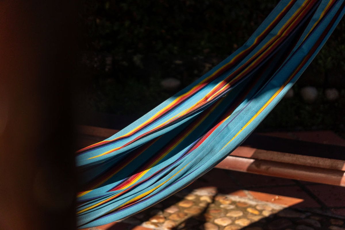 Cozy bedroom with wooden beams and lake views at Guatape vacation home