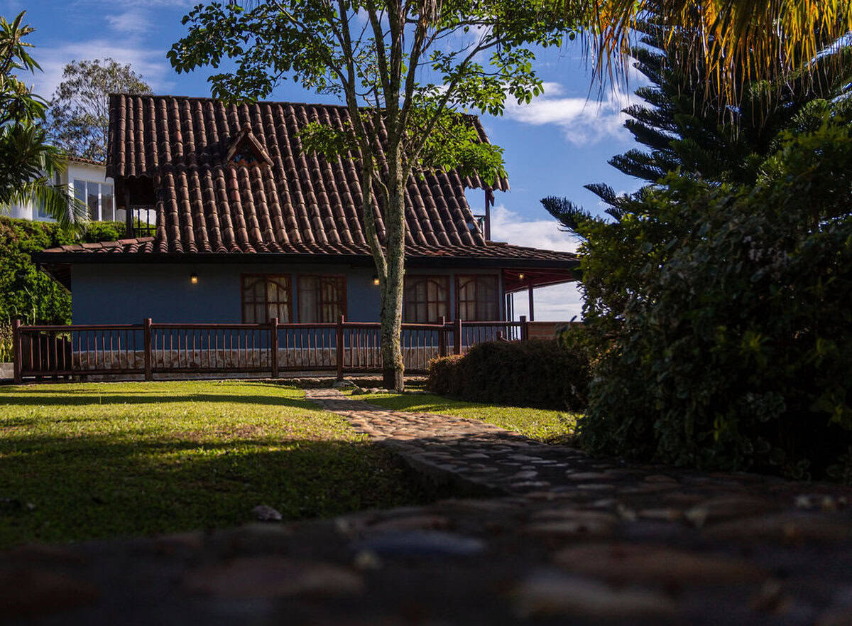 Rustic dining area with panoramic windows overlooking Guatape reservoir