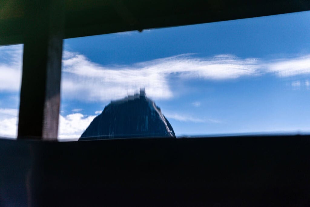 Cozy bedroom with wooden beams and lake views at Guatape vacation home