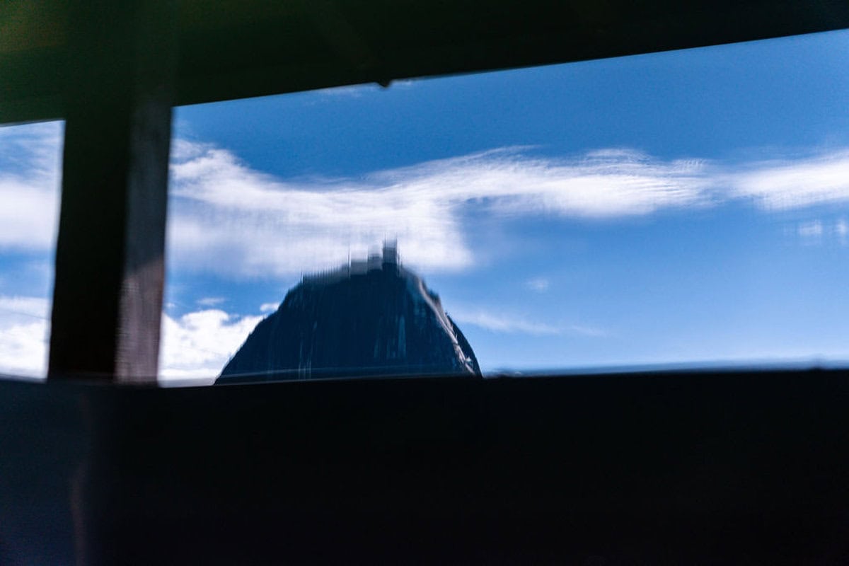 Cozy bedroom with wooden beams and lake views at Guatape vacation home