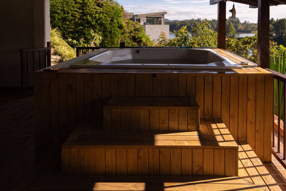 Rustic stone terrace with panoramic Guatape lake views at Finca Conejo Blanco vacation rental