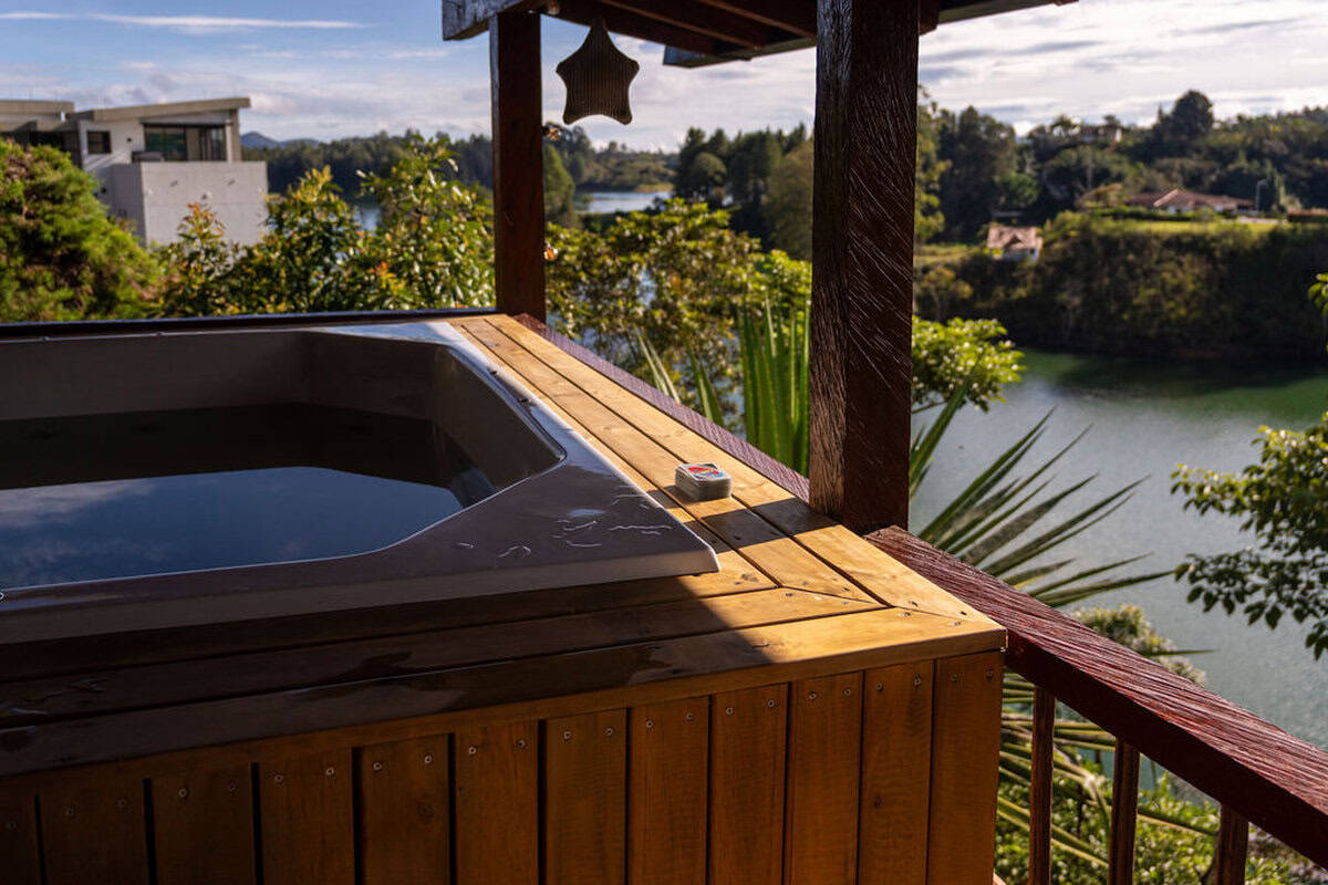 Heated jacuzzi overlooking Guatape lake and mountains at countryside finca Colombia