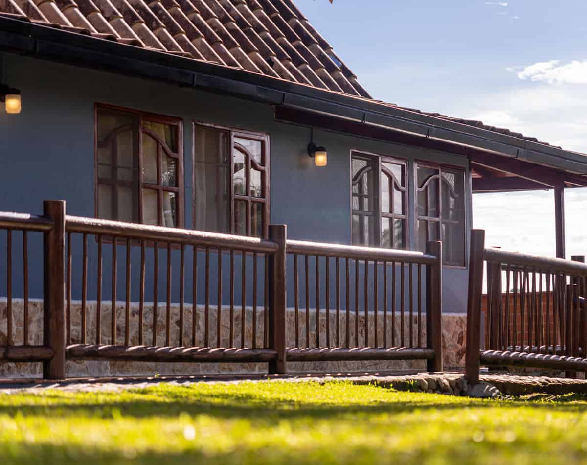 Rustic dining area with panoramic windows overlooking Guatape reservoir