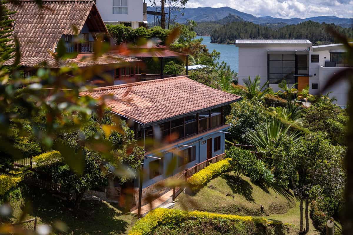 Rustic dining area with panoramic windows overlooking Guatape reservoir