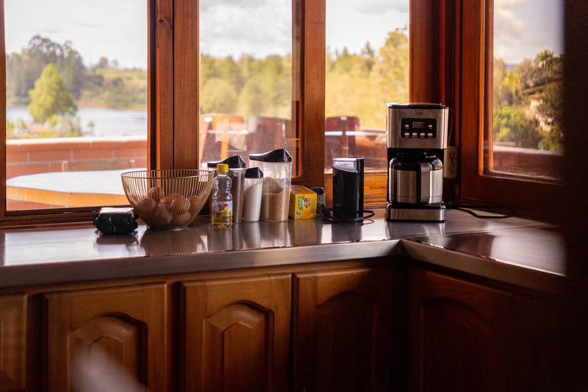 Freshly brewed coffee with scenic river view from Finca Conejo Blanco kitchen.