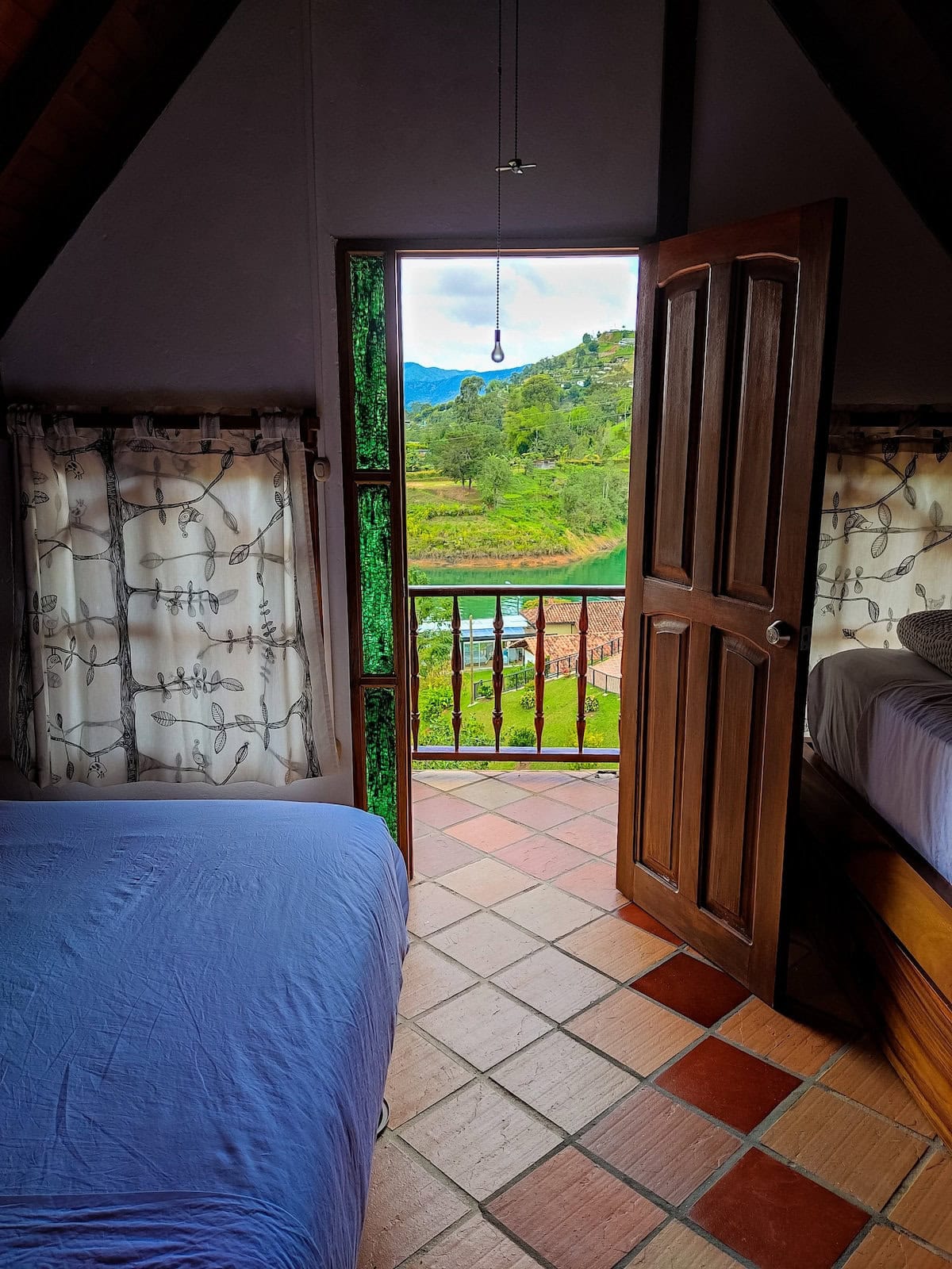Scenic bedroom balcony view overlooking hills and lake