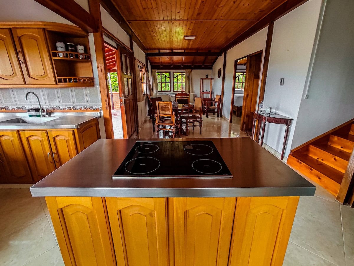 Cozy kitchen and dining area at CMS Finca Conejo Blanco with wooden cabinetry and rustic decor.