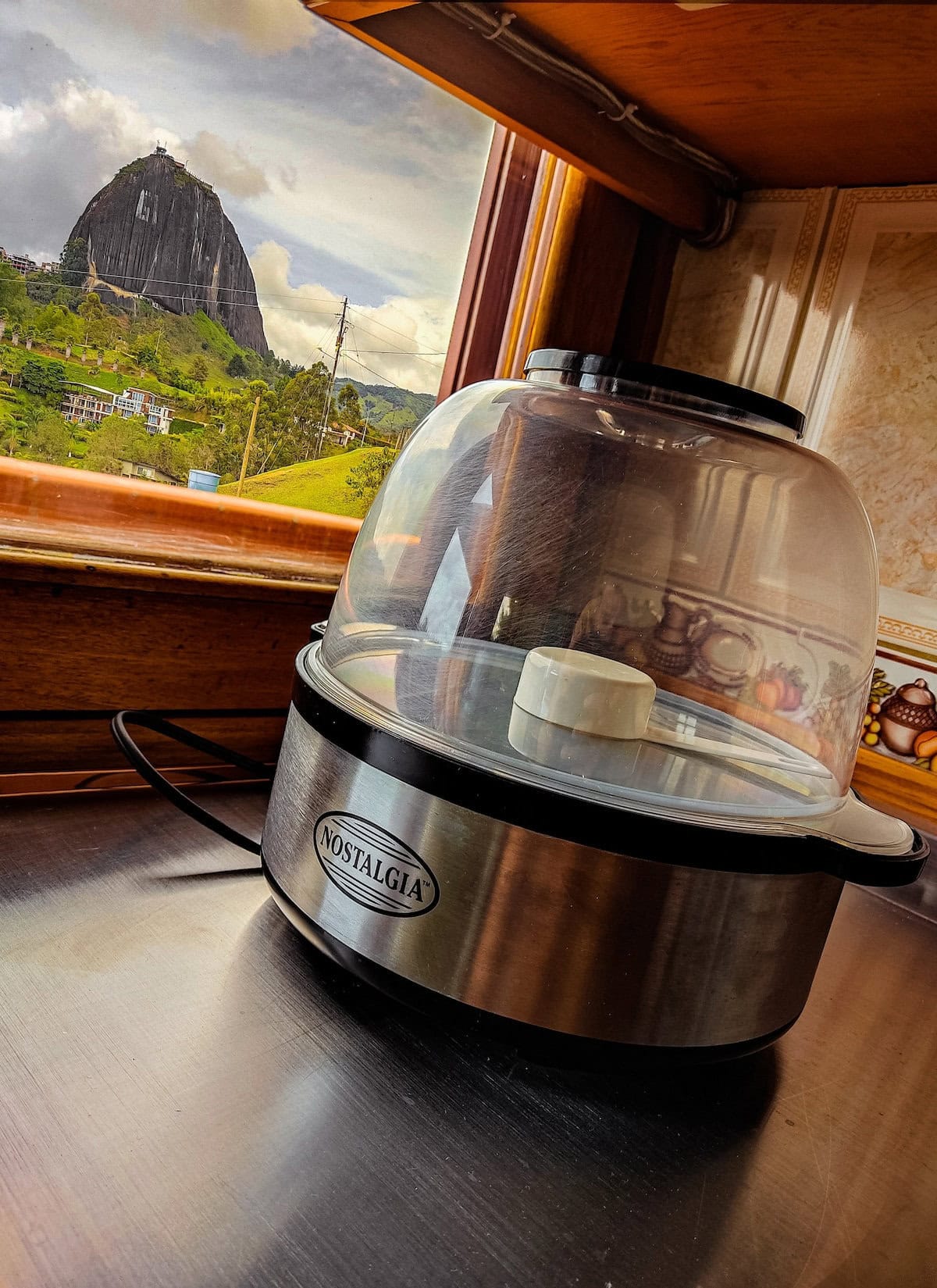 Stainless steel food steamer with glass lid at Finca Conejo Blanco, scenic mountain view.