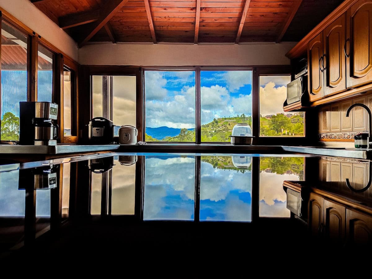 Modern kitchen with scenic mountain view at Finca Conejo Blanco, Costa Rica.